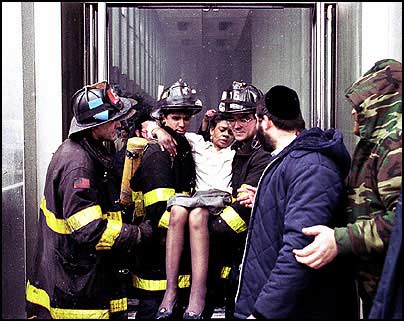 Firefighters rescuing a woman injured in the first World Trade Center attack
